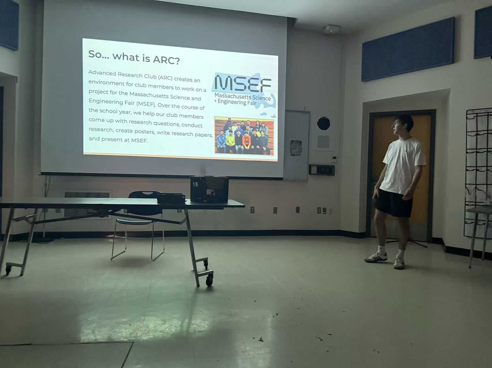 Student presenting a research poster at a science fair